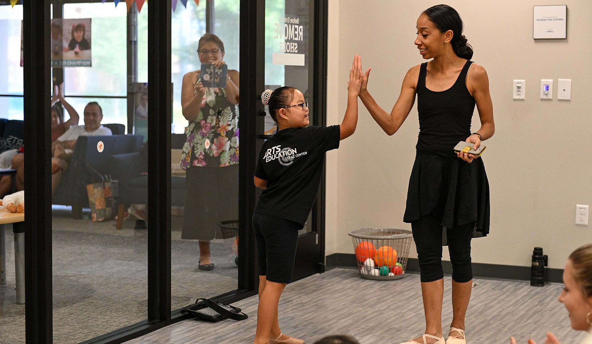 ballet teaching is giving student a high five